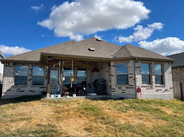 rear view of house featuring a yard and a patio area