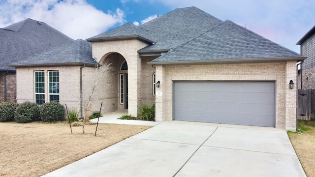 french country style house featuring a garage