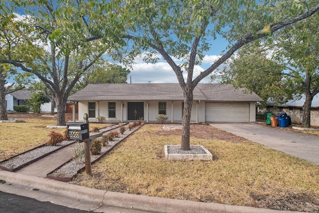 ranch-style home with a front lawn and a garage