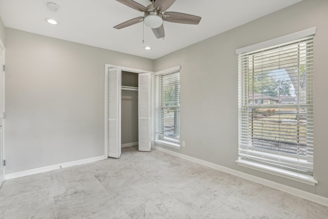 unfurnished bedroom featuring multiple windows, ceiling fan, and a closet