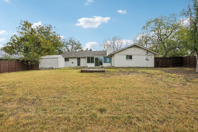 rear view of house with a yard