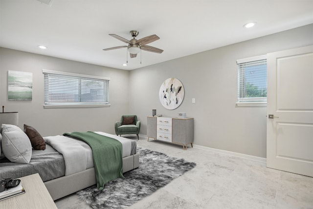 bedroom featuring ceiling fan and multiple windows