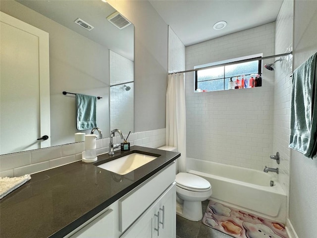 full bathroom with vanity, toilet, and shower / bath combo with shower curtain