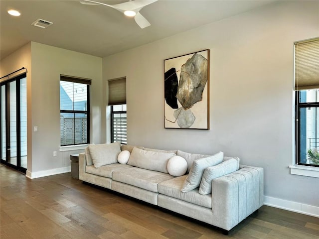 living room with dark hardwood / wood-style floors and ceiling fan