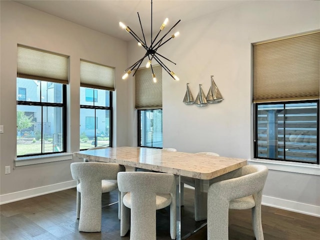 dining area with dark hardwood / wood-style floors and a chandelier