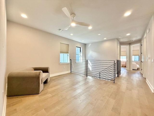 sitting room featuring light hardwood / wood-style floors and ceiling fan