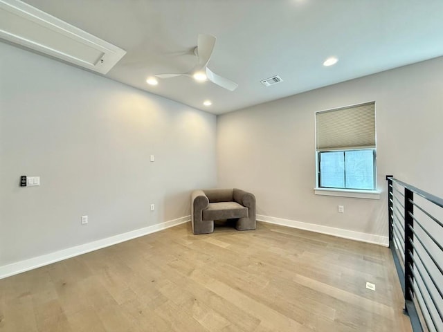 unfurnished room with ceiling fan and light wood-type flooring