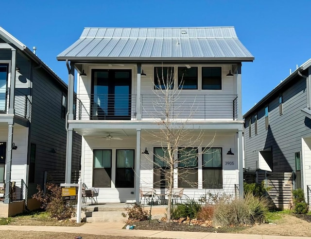 rear view of property featuring ceiling fan and a balcony