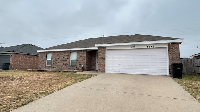 single story home featuring a front yard and a garage