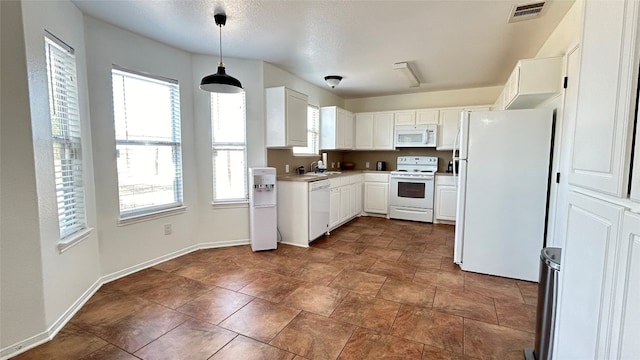 kitchen with white cabinets, decorative light fixtures, sink, and white appliances