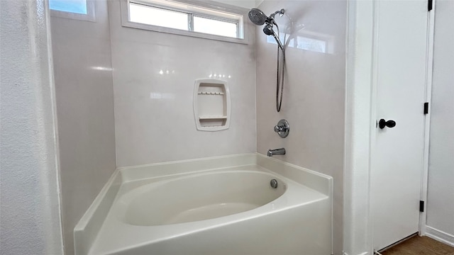 bathroom with a healthy amount of sunlight and shower with separate bathtub