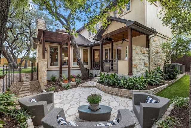 back of house with ceiling fan and a patio area