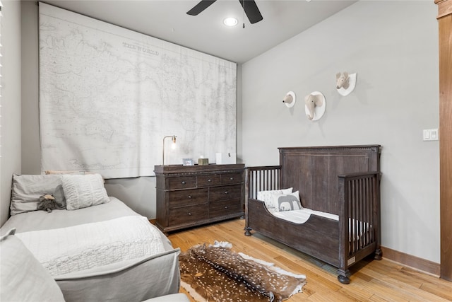 bedroom featuring light wood-type flooring and ceiling fan