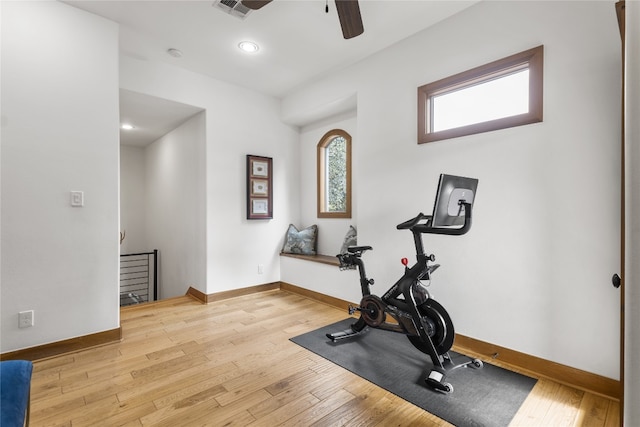 exercise room featuring light wood-type flooring and ceiling fan