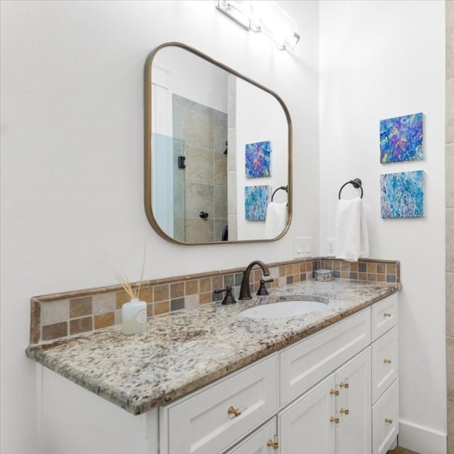 bathroom with tasteful backsplash and vanity