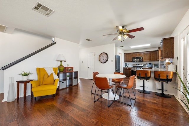 dining room with dark hardwood / wood-style flooring, ceiling fan, and sink