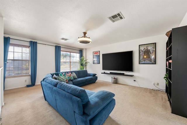 living room featuring light carpet and a textured ceiling