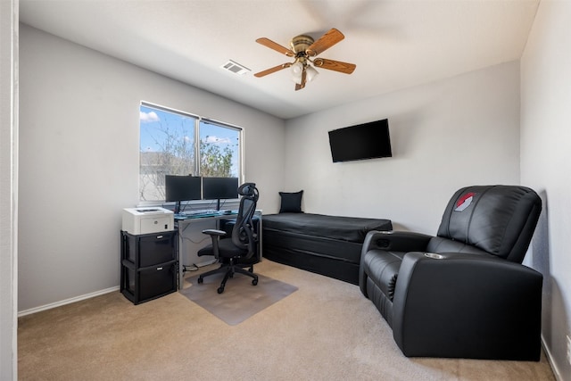 carpeted office space with ceiling fan