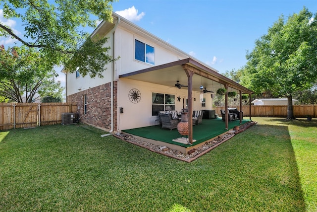 back of property with a lawn, a patio area, ceiling fan, and central air condition unit