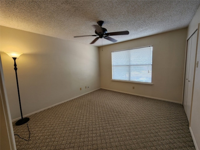 unfurnished room with dark colored carpet, a textured ceiling, and ceiling fan