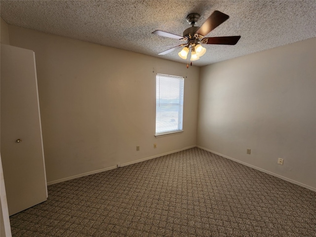 carpeted spare room featuring a textured ceiling and ceiling fan