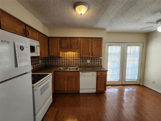 kitchen featuring french doors, dark hardwood / wood-style floors, backsplash, sink, and white appliances