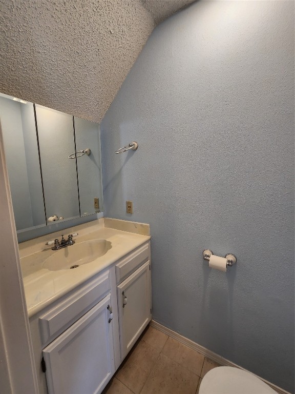 bathroom featuring vanity, toilet, and tile patterned floors