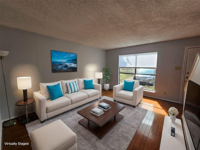 living room featuring hardwood / wood-style floors and a textured ceiling