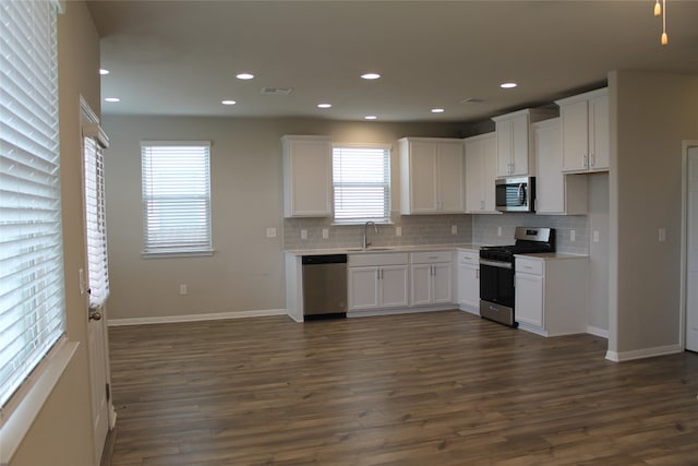 kitchen featuring white cabinets, dark wood-type flooring, and appliances with stainless steel finishes