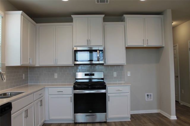 kitchen featuring dark hardwood / wood-style flooring, white cabinetry, sink, and stainless steel appliances