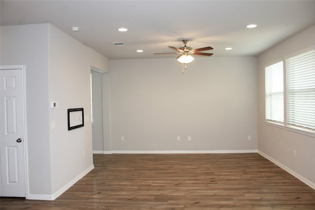 spare room with ceiling fan and dark wood-type flooring