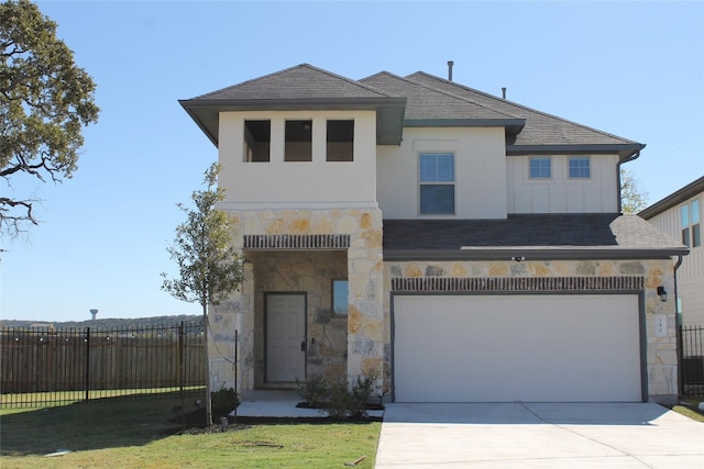 view of front of home featuring a garage and a front lawn