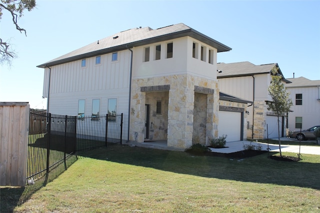 back of property with a garage and a lawn