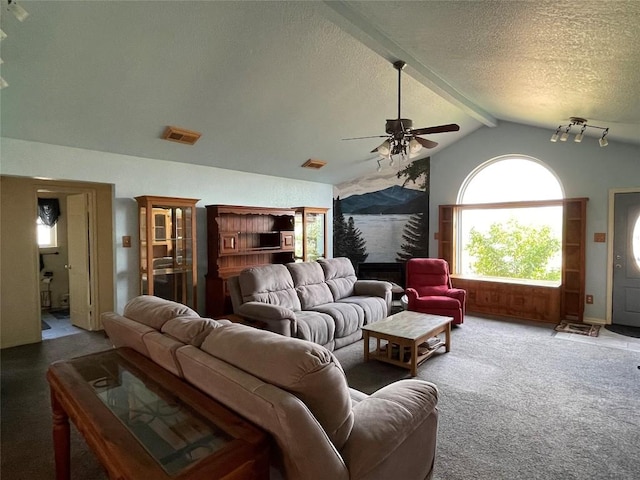 carpeted living room featuring ceiling fan, lofted ceiling with beams, and a textured ceiling