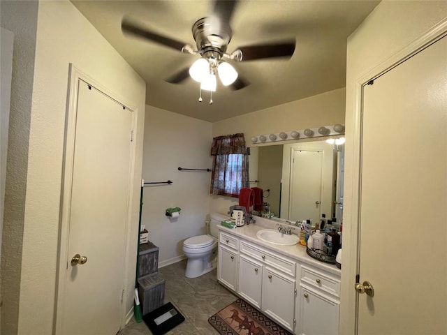 bathroom featuring ceiling fan, tile patterned flooring, vanity, and toilet