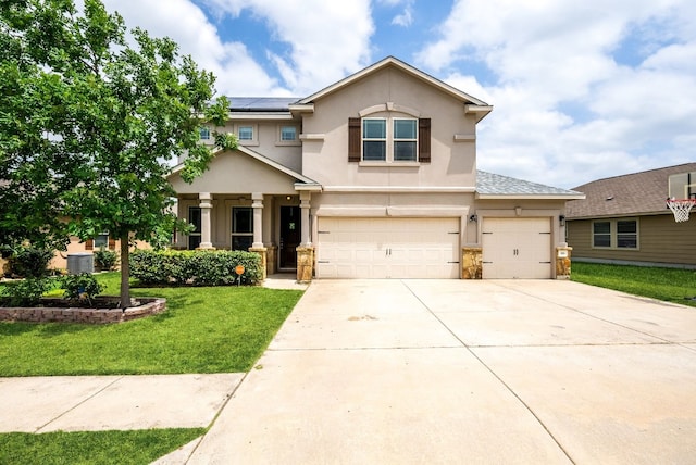 view of front of house with a front yard and a garage