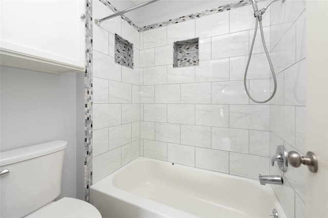 bathroom with tiled shower / bath and toilet