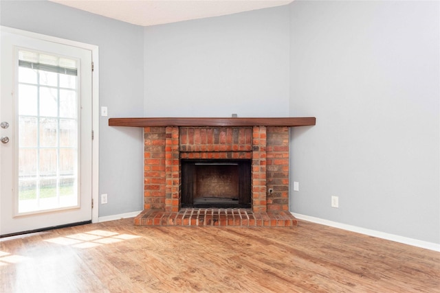 unfurnished living room with hardwood / wood-style flooring and a fireplace