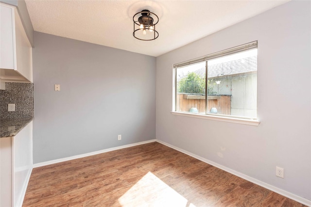 unfurnished dining area featuring hardwood / wood-style floors