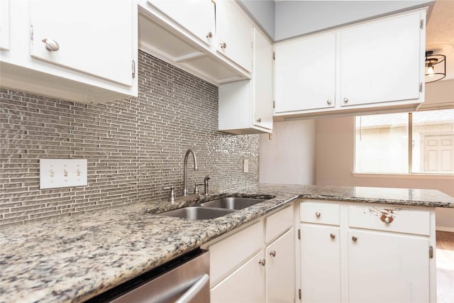 kitchen with white cabinetry, sink, and decorative backsplash