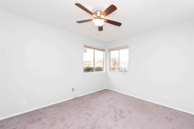 spare room with ceiling fan, a textured ceiling, and carpet flooring