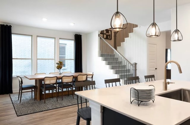 dining room featuring sink and light hardwood / wood-style floors