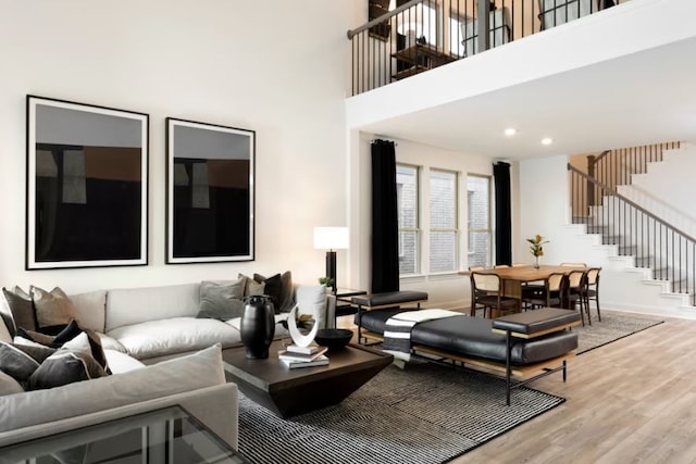 living room with a high ceiling and wood-type flooring