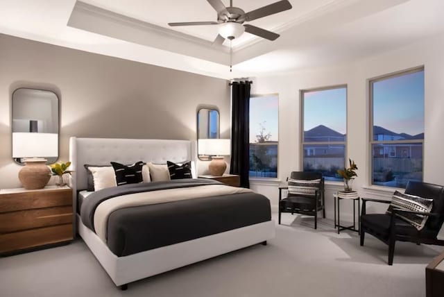 bedroom with ornamental molding, a tray ceiling, and ceiling fan