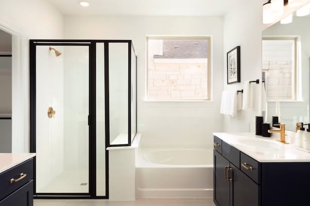 bathroom featuring vanity, shower with separate bathtub, and tile patterned floors