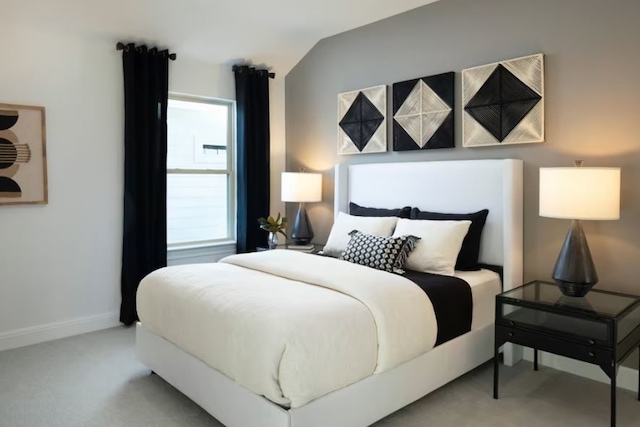 bedroom with carpet and vaulted ceiling