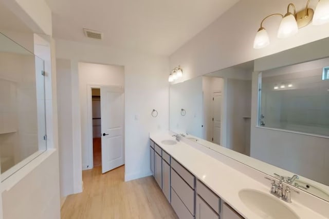 bathroom with vanity, hardwood / wood-style floors, and walk in shower