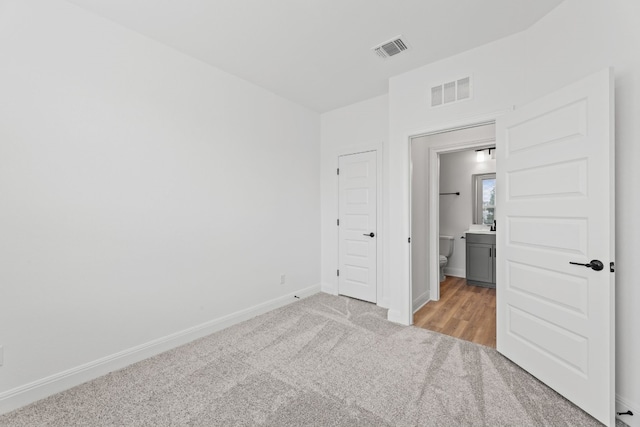 unfurnished bedroom featuring light colored carpet