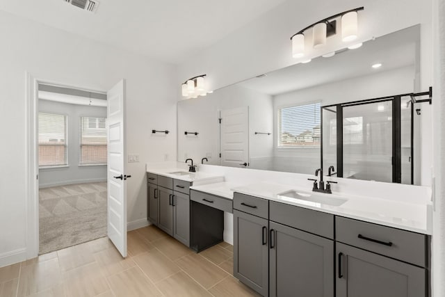 bathroom featuring vanity and a shower with shower door