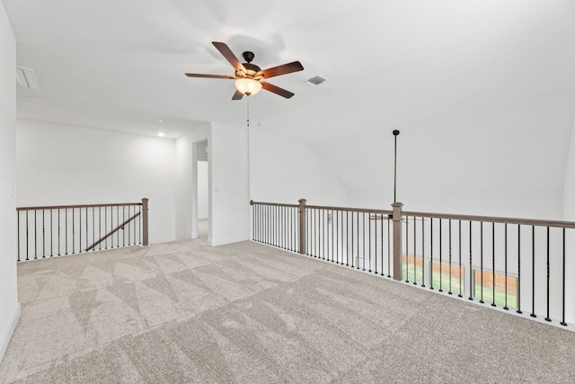 spare room with light carpet, ceiling fan, and lofted ceiling